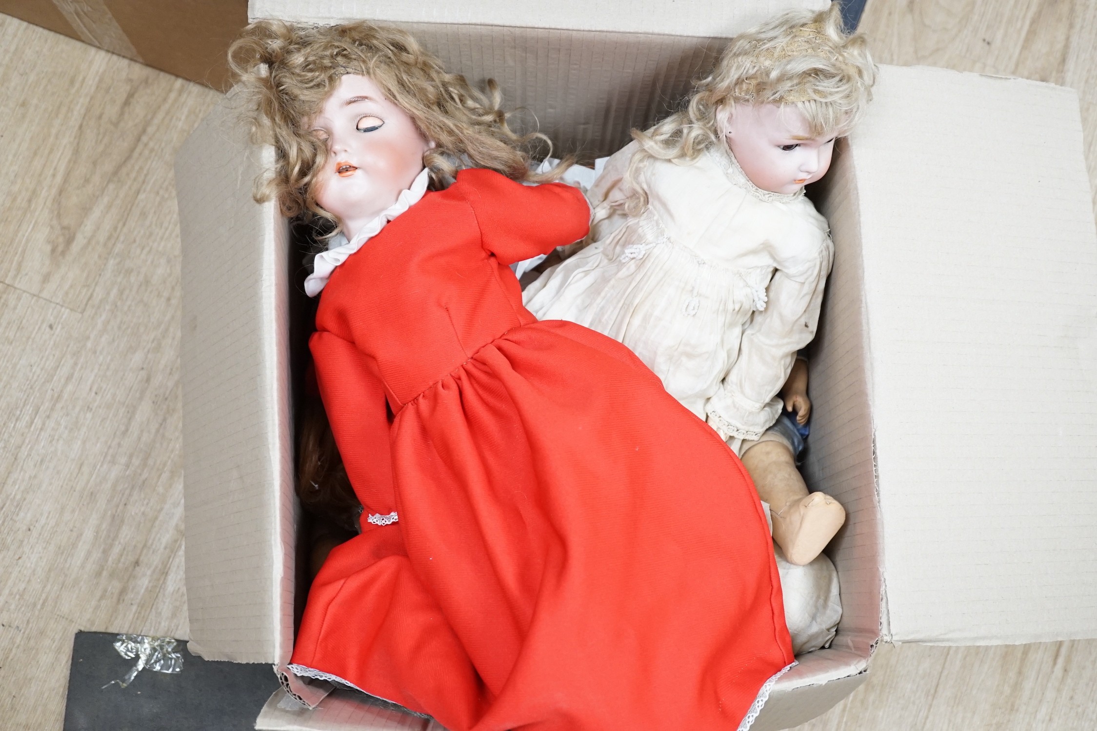 Two Kammer and Reinhardt bisque headed dolls, a wax over composition doll, various other bisque headed dolls and a few single heads and a collection of miniature dolls